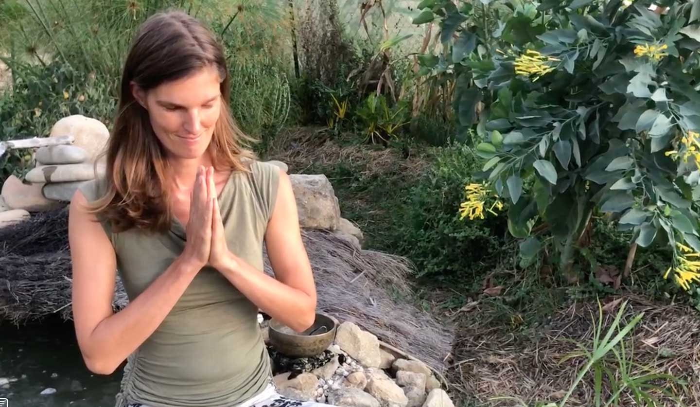 rianne with hands in prayer position after meditation