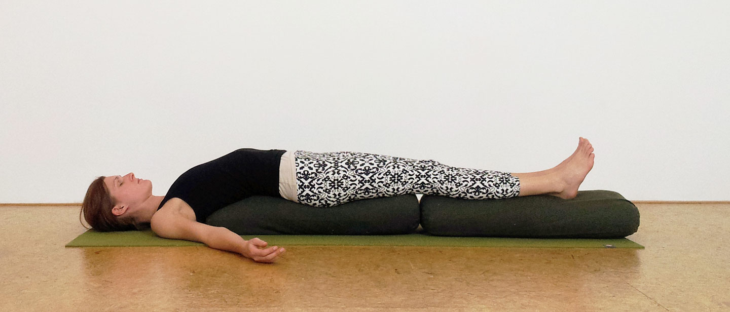 supported bridge restorative yoga pose