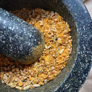 ayurvedic spice mix in a pestle and mortar